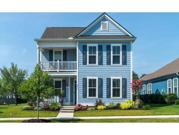 Charming two-story home with light blue siding, black shutters, and a quaint second-story porch at 2017 Geranium Ln, Johns Island, SC 29455