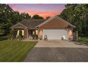 Charming brick home featuring a two-car garage, well-manicured landscaping, and inviting curb appeal at 214 Deer Ridge Court Ct, Huger, SC 29450