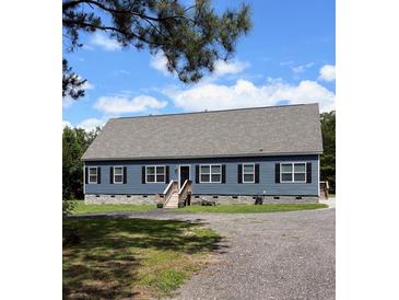 Charming one-story home with blue siding, black shutters, and a gravel driveway at 2460 Bama Rd, Cottageville, SC 29435