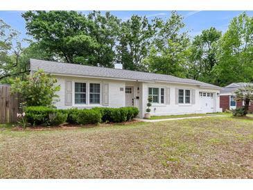 Charming one story home featuring a well manicured lawn, shuttered windows and brick exterior at 5028 Victoria Ave, North Charleston, SC 29405