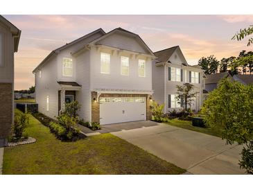 Charming two-story home featuring a two-car garage, manicured lawn, and inviting curb appeal at 515 Purple Finch Rd, Summerville, SC 29486