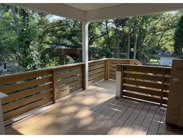 Spacious outdoor deck featuring wood railing and tree-lined backyard, perfect for relaxing and entertaining at 5513 Blackwell Ave # B, North Charleston, SC 29406