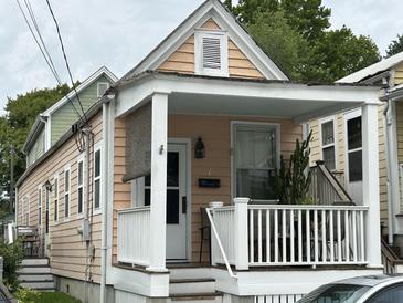 Charming home featuring a covered front porch with white railing and neutral exterior paint at 7 Dingle St, Charleston, SC 29403
