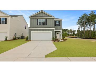 Charming two-story home with a well-manicured lawn and a two-car garage on a beautiful sunny day at 1035 Forrest Creek Dr, Summerville, SC 29483