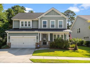 Charming two-story home features an attached garage, manicured lawn, and welcoming front porch at 1300 Enfield Ln, Mount Pleasant, SC 29466