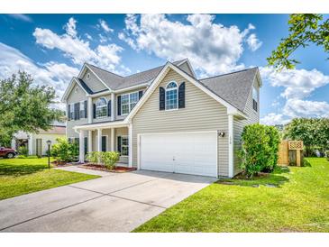Charming two-story home featuring a well-maintained lawn, two-car garage and classic architectural details at 170 Highwoods Plantation Ave, Summerville, SC 29485