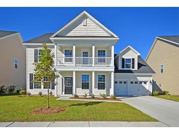 Charming two-story home with a well-manicured lawn and a two-car garage at 1816 Nola Run, Summerville, SC 29485