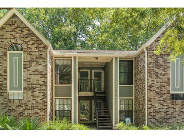 Brick exterior with inviting front entrance and stairs leading to the second level condos at 1872 Montclair Dr # C, Mount Pleasant, SC 29464