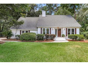 Charming one-story home features a well-maintained lawn and inviting front entrance with decorative shutters at 220 Runnymede Ln, Summerville, SC 29485