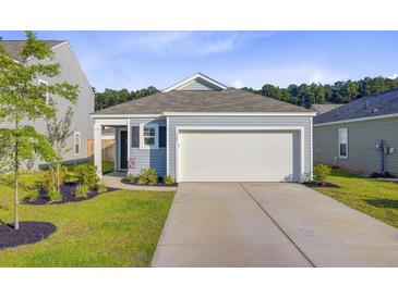 Charming single-story home with a two-car garage, well-manicured lawn, and a welcoming entrance at 325 Coral Sunset Way, Summerville, SC 29486