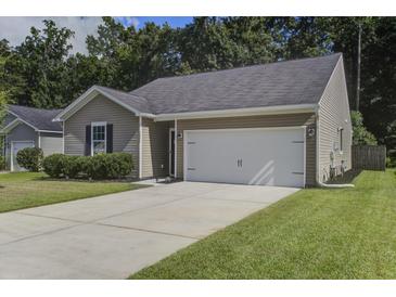 Charming single-story home featuring a two-car garage, neutral siding, and a well-manicured lawn at 3806 Sourwood Ct, Ladson, SC 29456