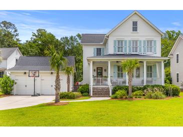 Charming two-story home with a spacious front porch and a detached garage featuring a basketball hoop at 3870 Fifle St, Mount Pleasant, SC 29466