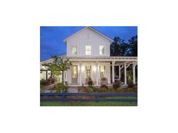 Charming white farmhouse with a welcoming front porch, perfect for enjoying quiet evenings at 617 Saturn Rocket St, Charleston, SC 29492