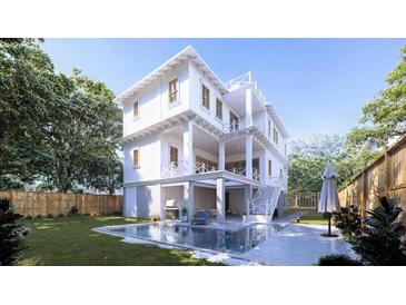 Stunning backyard featuring a pool, outdoor grilling area, and white exterior of a charming home at 814 Palm Blvd, Isle of Palms, SC 29451