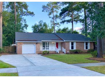 Charming single-story home features a brick facade, manicured lawn, and attached garage at 109 Garbon Dr, Summerville, SC 29485