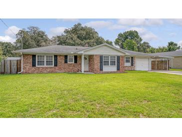 Charming brick home with green lawn, black shutters and attached carport at 113 Jackson Rd, Ladson, SC 29456