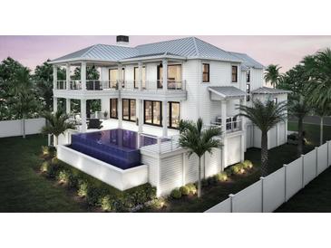 Beautiful two-story home exterior showcases a private pool, balconies, and lush landscaping at 2879 Marshall Blvd, Sullivans Island, SC 29482