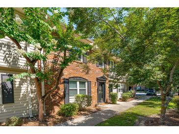 Charming brick townhouse with lush landscaping and a welcoming entrance at 415 Parkdale Drive # E-8, Charleston, SC 29414