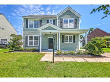Charming two-story home with a well-manicured lawn and a welcoming front porch at 4847 Cane Pole Ln, Summerville, SC 29485