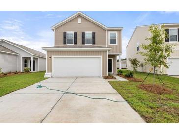Inviting two-story home with a spacious two-car garage and well-maintained lawn at 5005 Ferry Field Dr, Summerville, SC 29485