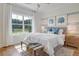 Bedroom with a large window, wood floors, and a cozy sitting bench at 173 Fiddleback Dr, Summerville, SC 29486