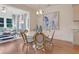 Bright dining area with white round table and four chairs, hardwood floors, and an open concept design at 173 Fiddleback Dr, Summerville, SC 29486