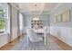 Dining room with white table, gray chairs, and a globe chandelier at 173 Fiddleback Dr, Summerville, SC 29486