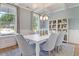 Formal dining room with white table and gray chairs, chandelier and built-ins at 173 Fiddleback Dr, Summerville, SC 29486
