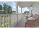 Relaxing covered porch with wicker chairs, overlooking a tree-lined street at 173 Fiddleback Dr, Summerville, SC 29486
