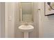 Small powder room with pedestal sink, mirror, and shiplap walls at 173 Fiddleback Dr, Summerville, SC 29486