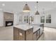 Modern kitchen featuring an island with white countertops, modern light fixtures, and open layout at 1075 Capersview Ct, Awendaw, SC 29429