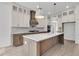 Well-lit kitchen featuring an island with white countertops and stylish pendant lighting at 1075 Capersview Ct, Awendaw, SC 29429