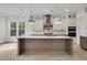 Spacious kitchen with a large island, stainless steel appliances, and custom cabinetry at 1075 Capersview Ct, Awendaw, SC 29429
