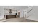 Bright, open kitchen with modern appliances, island, and adjacent staircase at 1075 Capersview Ct, Awendaw, SC 29429
