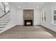 Open-concept living space with a fireplace, staircase, and ample natural light at 1075 Capersview Ct, Awendaw, SC 29429