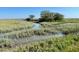 Scenic marsh view with grassy banks and waterways at 1075 Capersview Ct, Awendaw, SC 29429
