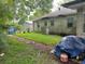 Overgrown backyard with a walkway and partially visible house at 1908 Savage Rd, Charleston, SC 29407