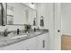 Stylish bathroom with a double sink vanity, granite countertop, and modern black fixtures at 4036 Azalea Farms Way, McClellanville, SC 29458