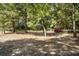Paddocks and stables with wooden fencing and trees at 175 Maria Stuart Ln, Varnville, SC 29944