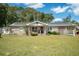 Brick ranch house with solar panels, porch, and large yard at 175 Maria Stuart Ln, Varnville, SC 29944