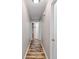 Long hallway with wood-look floors and doors to other rooms at 175 Maria Stuart Ln, Varnville, SC 29944