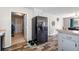Black stainless steel refrigerator is in this kitchen with wood-look floors at 175 Maria Stuart Ln, Varnville, SC 29944