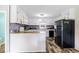 Bright kitchen features white cabinets, wood-look floors, and modern appliances at 175 Maria Stuart Ln, Varnville, SC 29944