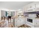 Bright kitchen features white cabinets, wood-look floors, and modern appliances at 175 Maria Stuart Ln, Varnville, SC 29944