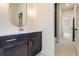 Modern bathroom boasts a dark wood vanity, gold hardware, and a stylish oval mirror at 1619 Zurlo Way, Johns Island, SC 29455