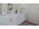 Bathroom boasts double vanity, white cabinets, and marble countertop at 507 Fiskdale Cir, Summerville, SC 29486