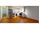 Galley kitchen boasting stainless steel appliances and wood flooring at 40 Bee St # 111, Charleston, SC 29403