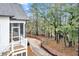 Backyard area featuring a screened-in porch and a backdrop of serene, mature trees at 1153 Oak Bluff Ave, Charleston, SC 29492