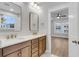 Modern bathroom boasting a double vanity with quartz countertops, gold faucets, and framed mirrors at 1153 Oak Bluff Ave, Charleston, SC 29492