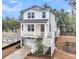 Inviting two-story white home featuring a charming porch, garage, and a well-lit entryway at 1153 Oak Bluff Ave, Charleston, SC 29492